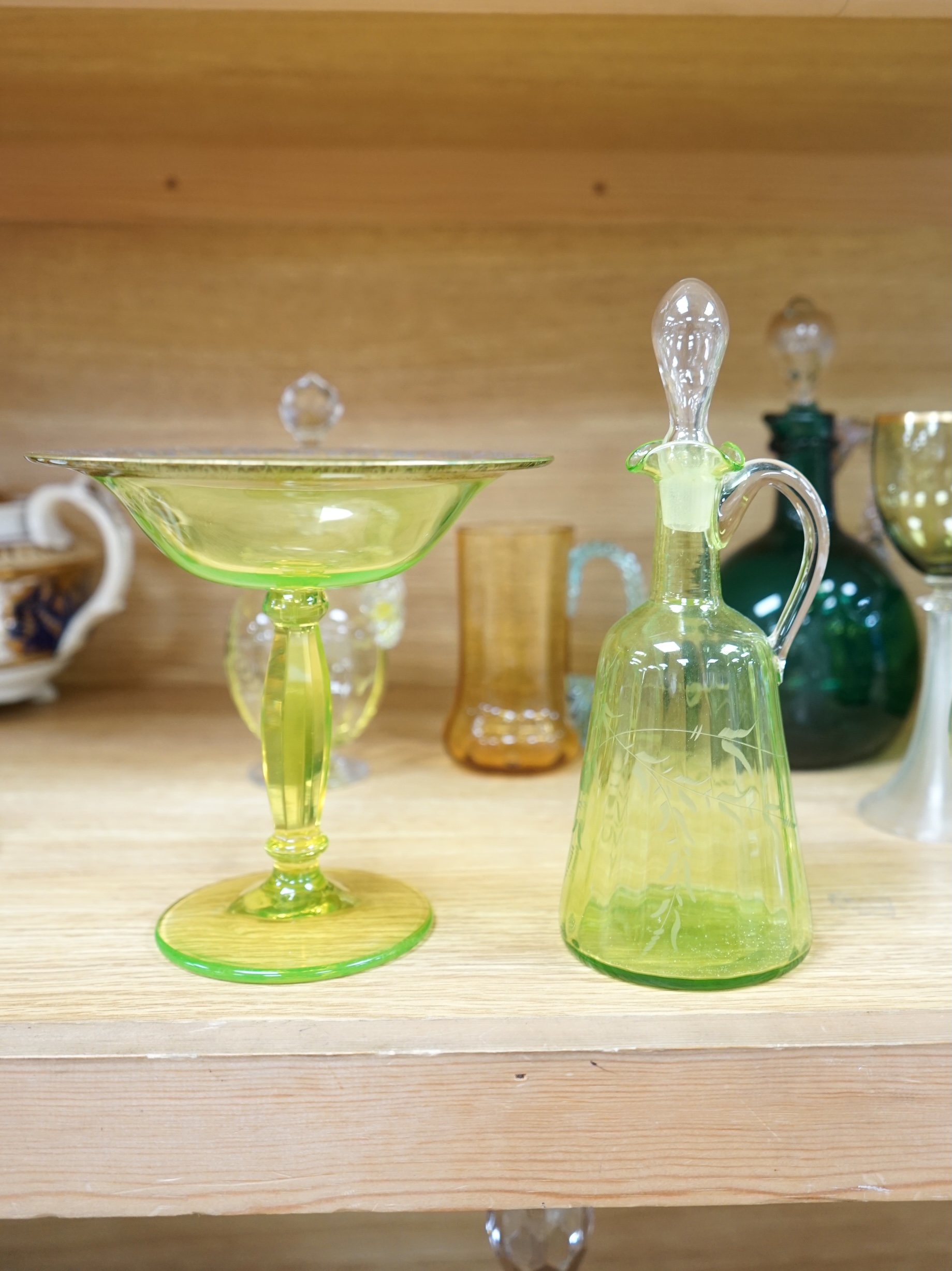 Ten glass items; a pair of green hock glasses, six liqueur decanters, a pedestal table centre and a mug. Condition - good.